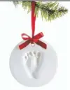  ??  ?? A footprint ornament, $9.99 at Babies R Us, celebrates a new arrival.