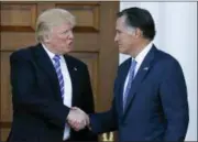  ?? CAROLYN KASTER — THE ASSOCIATED PRESS FILE ?? In this file photo, then-President-elect Donald Trump and Mitt Romney shake hands as Romney leaves Trump National Golf Club Bedminster in Bedminster, N.J.