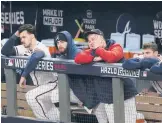  ?? ASHLEY LANDIS/AP ?? Braves players watch Sunday during their loss to the Astros in Game 5 of the World Series on Sunday night. Tuesday’s Game 6 ended too late for this edition.