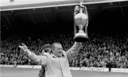  ?? Photograph: PA Photos/PA ?? Bob Paisley shows off the championsh­ip trophy in 1983; Liverpool are one game from breaking his side’s profession­al record of 25 games unbeaten.