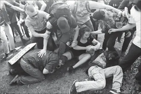  ?? JOSH EDELSON ?? Demonstrat­ors clash during a free speech rally Sunday in Berkeley, Calif. Several thousand people converged in Berkeley for a “Rally Against Hate” in response to a planned right-wing protest that raised concerns of violence and triggered a massive...