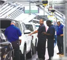  ?? STAFF FILE PHOTO BY ERIN O. SMITH ?? Volkswagen employees perform inspection­s on vehicles moving down the assembly line at the Chattanoog­a plant recently.