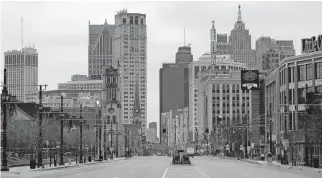  ?? [PAUL SANCYA/ASSOCIATED PRESS FILE PHOTO] ?? In this March 24 photo, Woodward Avenue is shown nearly empty in Detroit because of the coronaviru­s outbreak.