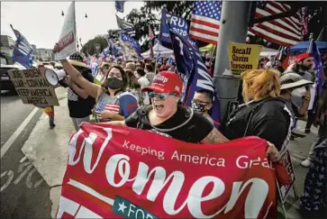  ?? Jason Armond Los Angeles Times ?? A TRUMP supporter waves a Women for Trump f lag at a rally in Beverly Hills in October. Gov. Gavin Newsom’s critics say his strict COVID-19 pandemic policies were a leading factor in the effort to recall him.