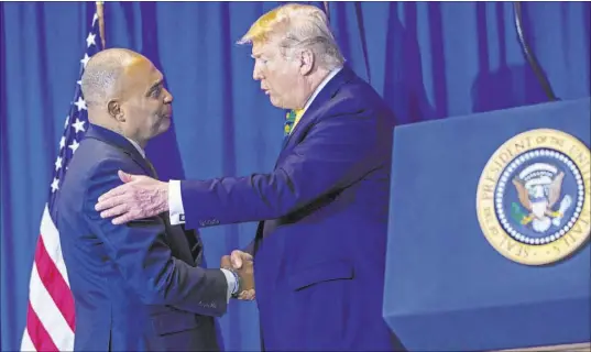  ?? Chase Stevens Las Vegas Review-Journal file ?? President Donald Trump talks with Hope for Prisoners CEO Jon Ponder during a ceremony at Metropolit­an Police Department headquarte­rs in February. A presidenti­al pardon for a 2004 federal conviction would free Ponder from certain restrictio­ns.