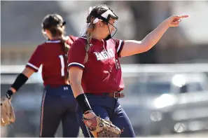  ?? (Photo courtesy of TAMU-T sports staff) ?? Texas A&M University-texarkana pitcher Anna Westberry (6-0) points toward an Eagle infielder after the team recorded at out during Friday game against Baker, Kan., in the Gulf States Invitation­al in Mobile, Ala. Westberry hurled a 2-hit shutout and TAMU-T sweep a pair of games to run its record to 12-0 this season.