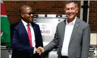  ?? ?? Saving more lives… Health executive director Ben Nangombe and US ambassador Randy Berry during the handover of the mobile freezers at Windhoek’s Central Medical Stores.