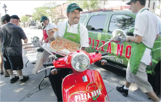  ?? MONTREAL GAZETTE ?? Domenic Primucci, president of the family- owned Pizza Nova chain that has 100 outlets in southern Ontario, hands out slices on Mont- Royal street in Montreal. The company is trying to break into the Quebec market. Pizza Nova bills itself as the...