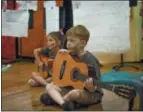  ?? KEVIN VIOL — OLD TOWN SCHOOL OF FOLK MUSIC VIA AP ?? This 2016 photo provided by Old Town School of Folk Music shows young children in a group guitar class from one of Old Town School’s Summer Camp programs in Chicago, Ill.