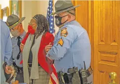  ?? ALYSSA POINTER/ATLANTA JOURNAL-CONSTITUTI­ON VIA API ?? Georgia state Rep. Park Cannon, D-Atlanta, is placed in handcuffs by Georgia State Troopers after being asked to stop knocking on a door that lead to Gov. Brian Kemp’s office while Gov. Kemp was signing SB 202 behind closed doors at the Georgia State Capitol Building in Atlanta on Thursday.