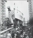  ??  ?? „ Crowds watch as HMS Belfast slides down the slipway at its launch on March 17, 1938.