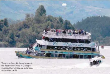  ?? — AFP ?? The tourist boat Almirante is seen in the Reservoir of Penol in Guatape municipali­ty in Antioquia, Colombia, on Sunday.