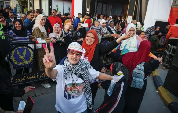  ?? Bloomberg ?? Supporters of President Abdel Fattah El Sisi at a polling station in the Ramses Square area of Cairo. About 40 million people voted for him to remain in power