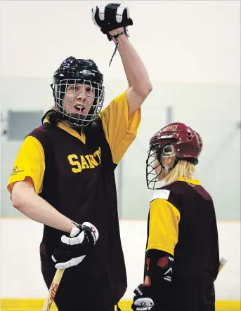  ?? CLIFFORD SKARSTEDT EXAMINER ?? St. Peter student Kaden Telford and Miranda Moorcroft celebrate a goal scored on Holy Cross during Special Olympics floor hockey qualifier action on Thursday at the Evinrude Centre.