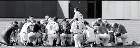  ?? ASSOCIATED PRESS ?? STEVE GARVEY, FORMER LOS ANGELES DODGERS PLAYER, LEADS A PRAYER FOR THE REPUBLICAN TEAM Washington. The annual GOP-Democrats baseball game raises money for charity. before the Congressio­nal baseball game Thursday in