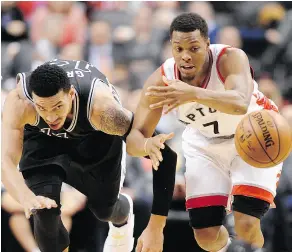  ?? FRANK GUNN / THE CANADIAN PRESS ?? San Antonio Spurs guard Danny Green and Toronto Raptors guard Kyle Lowry battle for a loose ball Tuesday at the Air Canada Centre.