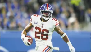  ?? Duane Burleson / Associated Press ?? New York Giants running back Saquon Barkley carries the ball against the Detroit Lions.