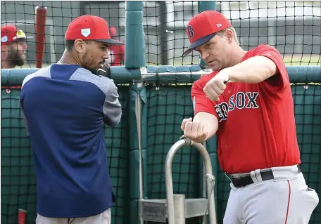  ?? HERALD STAFF FILE ?? MISSING PIECE: Mookie Betts, left, receives instructio­ns from hitting coach Tim Hyers during a spring training workout in Fort Myers, Fla., on Feb. 20, 2019.