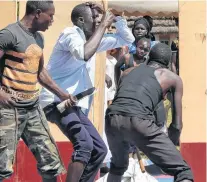  ?? AP PHOTO ?? Former child soldiers of the Lord’s Resistance Army (LRA) and community members perform songs at the end of a music therapy pilot programme in Gulu, Uganda.