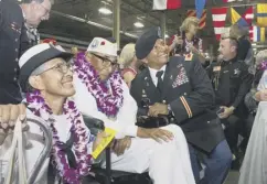  ??  ?? 0 Ray Chavez, centre, with daughter Kathleen, left, at a 2016 event in Honolulu marking the 75th anniversar­y of Pearl Harbor