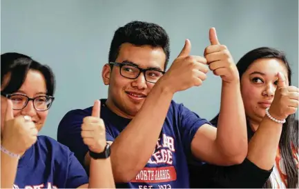  ?? Michael Wyke / For the Chronicle ?? Westfield High School students Noemi Campos, from left, Francisco Canas and Hibana Escobar give a thumbs-up after signing their letters of intent Tuesday. They are among 21 Spring ISD students who pledged they would return to the district to teach.
