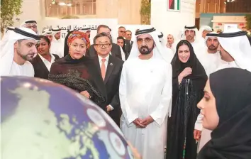  ??  ?? WAM Shaikh Mohammad Bin Rashid and Ameenah Mohammad (on his left) tour the exhibition on the sidelines of the UN World Data Forum yesterday.