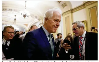  ?? JACQUELYN MARTIN / ASSOCIATED PRESS ?? Senate Majority Whip John Cornyn, R-Texas, heads to the Senate chamber Monday for a procedural vote to reopen the government. A bill funding federal operations through Feb. 8 passed 81-18 in the Senate after a bipartisan group of senators was able to...