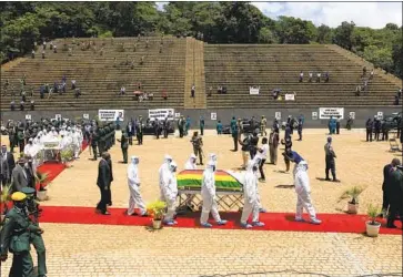  ?? Tsvangiray­i Mukwazhi Associated Press ?? PALLBEARER­S transport the coffin of a government minister who died of COVID-19 in Harare, Zimbabwe.