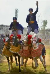  ?? — PTI ?? ‘ Nihangs’ or Sikh warriors display their horse riding skills during the annual fair of ‘ Hola Mohalla’ at Anandpur Sahib in Punjab on Friday.