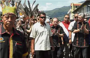  ?? — Bernama ?? Rich culture: Dr Ahmad Zahid (right) arriving for the launch of the 15th Kalimaran Festival in Tenom.