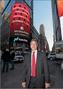  ?? SUBMITTED PHOTO ?? Meridian Chairman and CEO Chris Annas has a photo taken as his appearance outside of the Nasdaq exchange in New York City is announced on a jumbo screen.