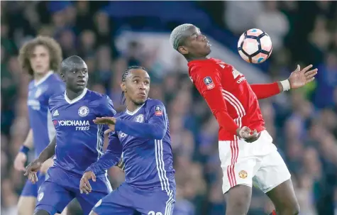  ?? — Reuters ?? Manchester United’s Paul Pogba in action with Chelsea’s Willian and Victor Moses.