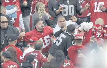  ?? BEN MARGOT — THE ASSOCIATED PRESS FILE ?? Fans fight in the stands during a preseason NFL game between the 49ers and Raiders in San Francisco on Aug. 20, 2011.