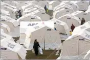  ?? KAMRAN JEBREILI / AP ?? People with their belongings arrive at the tents in Kharamanma­ras, southeaste­rn Turkey, Friday.