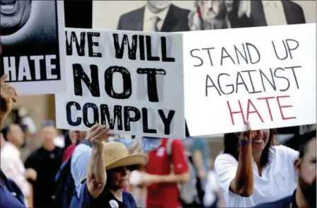  ?? MATT YORK — THE ASSOCIATED PRESS ?? People protest outside the Phoenix Convention Center, Tuesday in Phoenix. Protests were held against President Donald Trump as he planned to host a rally inside the convention center.