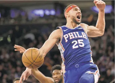  ?? SETH WENIG/AP ?? The 76ers’ Ben Simmons reacts after dunking during the first half of Sunday’s game against the New York Knicks in New York. Simmons had 20 points, 22 rebounds and Philadelph­ia won 108-105.
