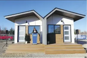  ?? GAVIN YOUNG ?? ATCO CEO Nancy Southern unveils two of the first tiny houses built for the Homes for Heroes Foundation project in Calgary. The transition­al homes project aims to help homeless vets get back on their feet.