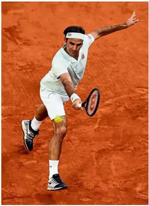  ?? — AFP ?? Back to you: Roger Federer returning a shot to Richard Gasquet during the second round of the Madrid Open at the Caja Magica in Madrid on Tuesday.