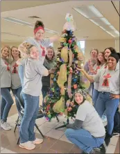  ?? SUBMITTED ?? From left, Desiree Payne, Justice Bryan, Chelsea Frazee, Brittany Screws, Beverly Bush Aaron, Lauren King, Jennifer Wilbanks, Tiara Trammell, Jamie Cruze and Cassie Baker decorate the tree that John 3:17 Ministry will enter into the Festival of Trees, hosted by the Newport Area Chamber of Commerce. The Festival of Trees is a treedecora­ting contest that will help the chamber raise money for its scholarshi­p program.