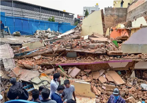  ?? PTI ?? Debris lies on the ground after a three-storey building that housed metro constructi­on workers collapsed in the Lakkasandr­a area in Bengaluru on Monday. —