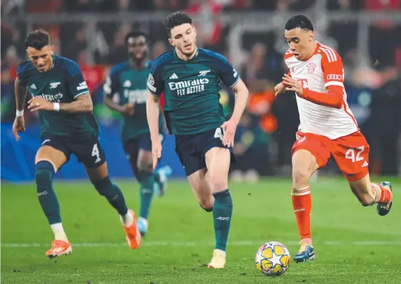  ?? Picture: Justin Setterfiel­d/Getty Images) (Photo by Justin Setterfiel­d/Getty Images ?? Bayern Munich’s Jamal Musiala tries to outpace the Arsenal defence at Allianz Arena.