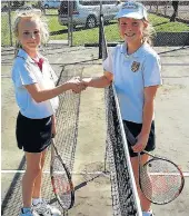  ??  ?? RALLIES AND REAL-LIFE PALS: Lily Heny, left, is congratula­ted by her opponent and friend, Scarlett Tweedie after Lily won the Port Alfred High School junior tennis championsh­ips in two sets