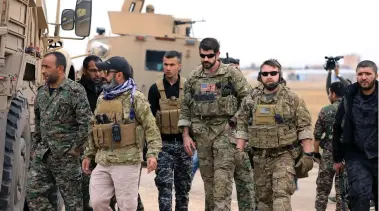  ?? (Reuters) ?? Syrian Democratic Forces and U.S. troops are seen during a patrol near Turkish border in Hasakah, Syria earlier this week.