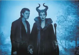  ?? Frank Connor / Walt Disney Pictures ?? Disney’s “Maleficent,” here featuring Sam Riley as Diaval and Angelina Jolie as Maleficent, is a kids movie with a death toll.