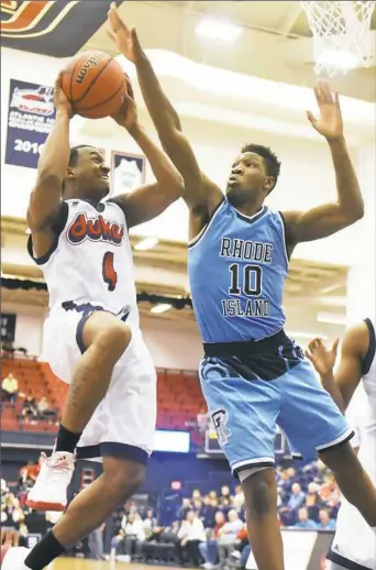  ?? Haley Nelson/Post-Gazette ?? 12) rallied past host TCU (145, 3-4). Rhode Island’s Cyril Langevine, right, goes for the block against Duquesne’s Rene Castro Saturday in an Atlantic 10 Conference game at Palumbo Center.