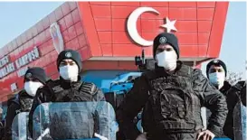  ?? AP ?? Riot police officers stand guard at the entrance of a courthouse Thursday during the trial of 475 defendants, including generals and fighter pilots, on the outskirts of Ankara.