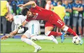  ??  ?? Liverpool's Mohamed Salah (R) falls with Real Madrid's Sergio Ramos leading to Salah being injured.