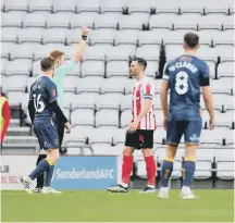  ?? ?? Corry Evans is booked by referee James Oldham.