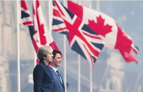  ?? SEAN KILPATRICK / THE CANADIAN PRESS ?? British Prime Minister Theresa May is greeted by Prime Minister Justin Trudeau as she arrives to Parliament Hill in Ottawa on Monday. The leaders confirmed they are working toward a new bilateral free trade deal to take effect after the U.K. achieves...