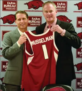  ?? David Gottschalk/NWA Democrat-Gazette ?? Getting help from Hall: Eric Musselman (left) receives a jersey from Athletic Director Hunter Yurachek at a press conference after his introducti­on as the new head coach of men's basketball at the University of Arkansas Monday, April 8, 2019, in Bud Walton Arena on the campus in Fayettevil­le. Riley Hall, the lone holdover from the Mike Anderson regime, has proven to be invaluable to Musselman and his staff.